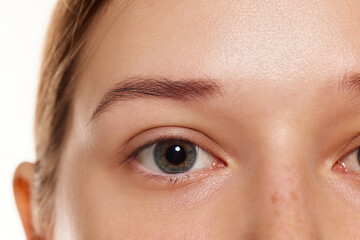 Cropped image of female model with beautiful eyes without makeup and with well-kept skin. Anti-aging treatment.