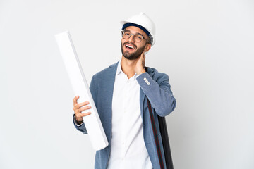 Young architect man with helmet and holding blueprints isolated on white background laughing