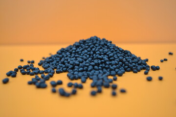 Black TPE compounds on an orange background
