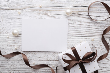 blank gift tag and gift box, rustic white wooden background - 694767330