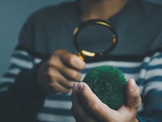 ESG environmental social investment business concept, businessman holding a magnifying glass...