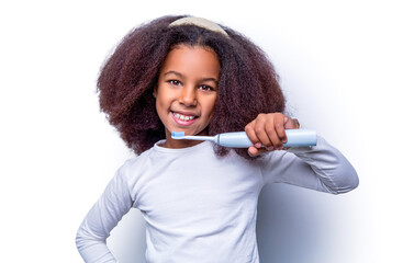 Little girl toothbrush closeup. Little cute african american girl brushing her teeth. Healthy teeth, toothpaste. Small girl, toothbrush. Multiracial girl brushes her teeth an electric toothbrush