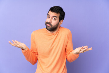 Fototapeta premium Caucasian handsome man over isolated purple background making doubts gesture