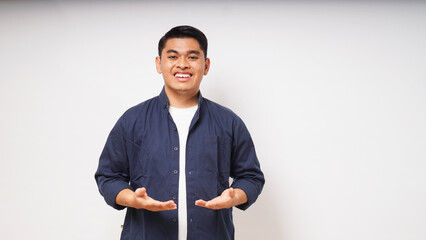 Young Asian man smiling with his hand holding something pose on white background