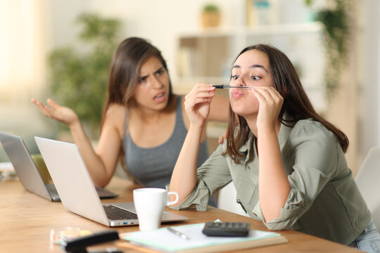Angry tele worker scolding to her lazy colleague