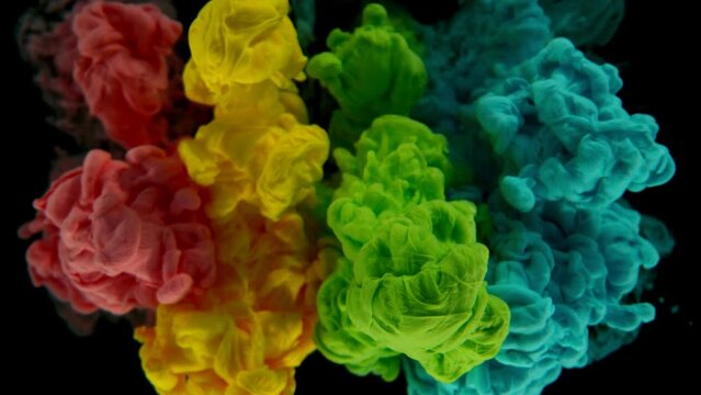 Super Slow Motion of Colored Paints Mixing in Water. Isolated on Black Background. Filmed on High Speed Cinema Camera, 1000fps.
