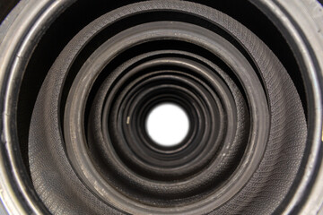 A tunnel of new car tires standing on a store counter with concentrated rings
