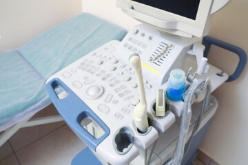 Fototapeta na wymiar Ultrasound machine and examination table in hospital, closeup