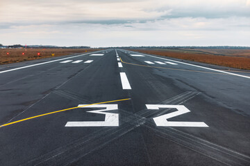 Airport runway with markings on the asphalt. The concept of travel and tourism