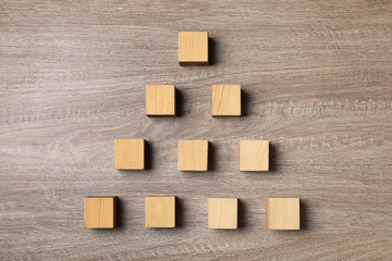 Blank cubes on wooden table, flat lay