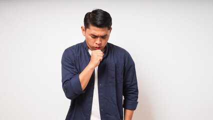 Young Asian man make coughing gesture on white background. studio shot