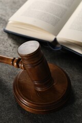 Law concept. Gavel and book on grey textured table, closeup