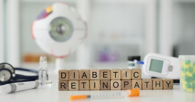 Diabetic ritinopathy inscription on wooden cubes on the table, close-up. Treatment of eye disease, diabetes mellitus