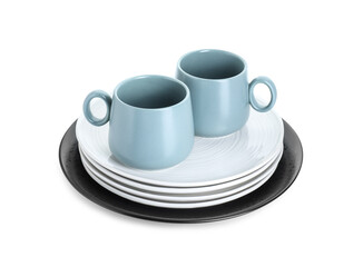 Beautiful ceramic plates and cups isolated on white