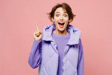 Young insighted smart proactive woman wear purple vest sweatshirt casual clothes holding index finger up with great new idea isolated on plain pastel light pink background studio. Lifestyle concept. © ViDi Studio
