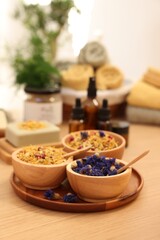 Dry flowers on wooden table indoors, space for text. Spa time