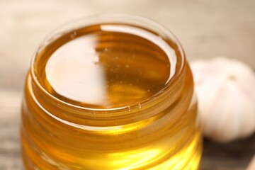 Jar with honey against blurred background, closeup