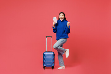 Traveler winner woman wear blue sweater casual clothes hold passport ticket bag isolated on plain...