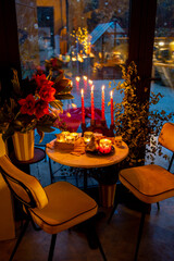 Beautifully decorated table for a New Year's holidays at cozy home during festive evening