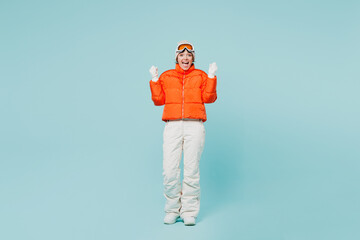 Full body young overjoyed skier woman wear warm padded windbreaker jacket hat ski goggles mask do...