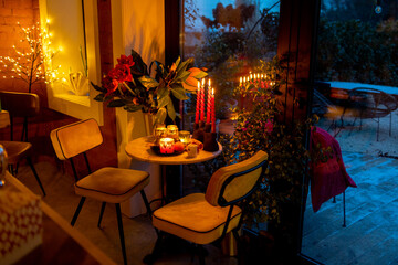 Beautifully decorated table for a New Year's holidays at cozy home during festive evening