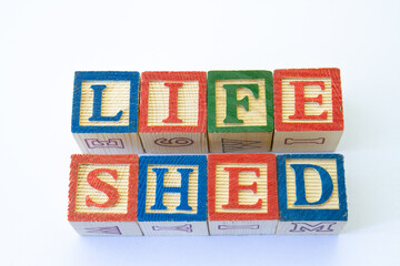 The phrase life shed displayed visually on a clear background with copy space