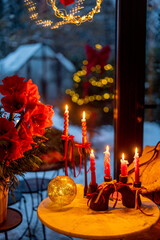 Beautifully decorated table with candles and garlands for a New Year's holidays at cozy home during festive evening