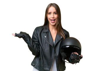 Young pretty caucasian woman with a motorcycle helmet over isolated background with shocked facial...