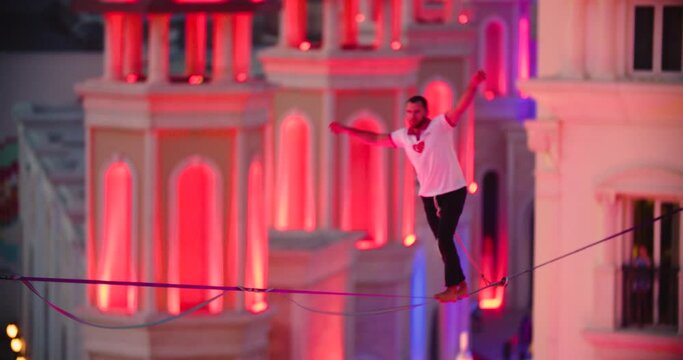 Man loses balance and falls off the slackline, hanging on safety line, sports 4k