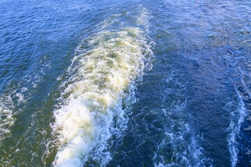 The wake of a ship. Aerial top view of a beautiful rail on the sea or ocean surface behind of speed...