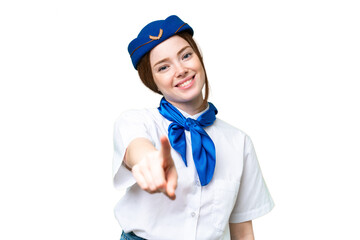 Airplane stewardess over isolated chroma key background points finger at you with a confident expression
