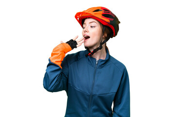 Young cyclist woman over isolated chroma key background yawning and covering wide open mouth with hand