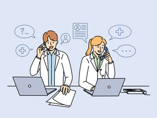 Doctors work in clinic telephone helpline and answer patients questions by phone standing near table with papers and computers. Two doctors with smile sign up clients for session with therapist