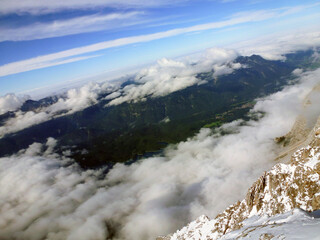 Obraz premium View from the mountain to the valley and the clouds above it. A picturesque panorama of wild nature