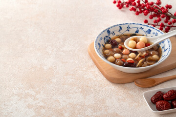 Homemade red and white tangyuan with syrup soup, dried longan pulp, red dates for Winter solstice.