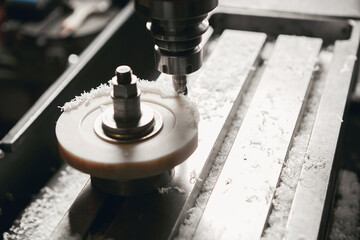 Grinding of plastic element on CNC machine. Manufacturing of the shock absorber support.