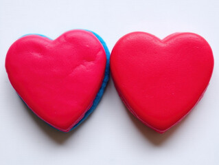 Fototapeta premium Two heart-shaped cookies side by side. The concept shows sweet romance.
