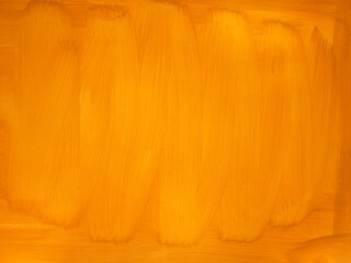 Close up texture orange color paint brush background. Painted wall with traces of brushes.