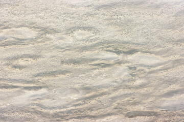 Frozen Snow on Water Surface in Pond, Macro Close-Up as Winter Background