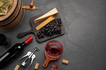 Winemaking. Flat lay composition with tasty wine and wooden barrel on gray table, space for text