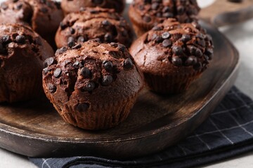 Tasty chocolate muffins on grey table, closeup