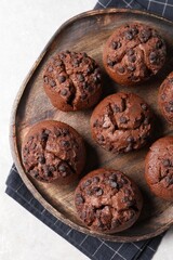 Tasty chocolate muffins on grey table, top view