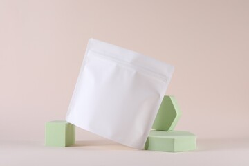 Presentation of white bag on pale pink background, space for text