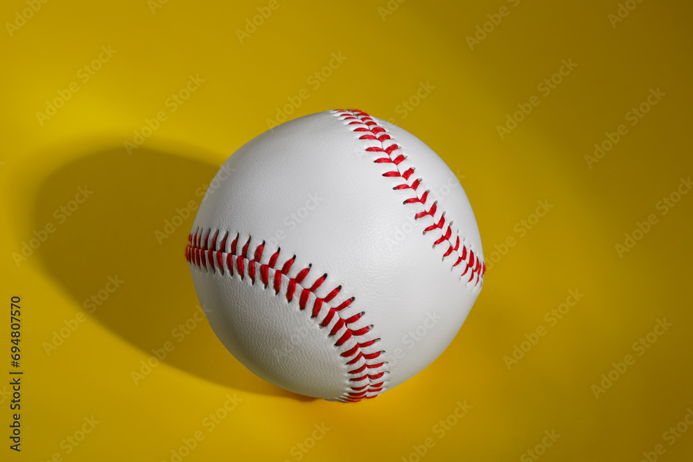 Poster One baseball ball on yellow background, top view