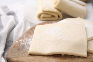 Raw puff pastry dough on table, closeup