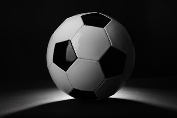 Naklejka premium One soccer ball in darkness. Sports equipment