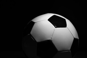 Fototapeta premium One soccer ball on black background, closeup. Sports equipment