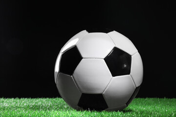 Fototapeta premium One soccer ball on green grass. Sports equipment