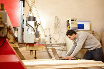 Man at the CNC machine. Tool with computer numerical control.