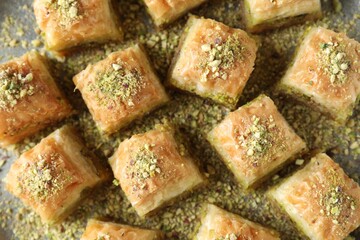 Delicious fresh baklava with chopped nuts on table, flat lay. Eastern sweets